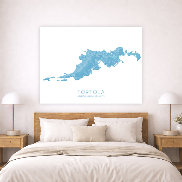 Framed map of Tortola on a wall above a bed in a bedroom.
