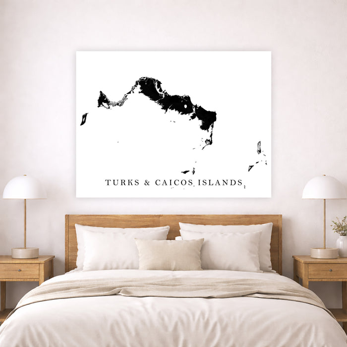 Map of Turks and Caicos Islands on a wall above a bed in a bedroom.