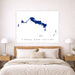 Map of Turks and Caicos on a wall above a bed in a bedroom.