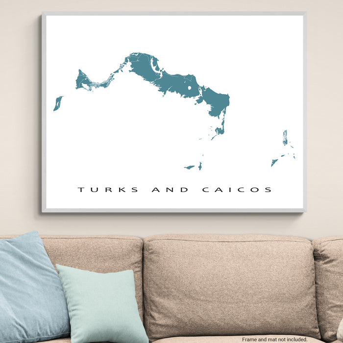 Framed map of Turks and Caicos on a wall above a sofa.