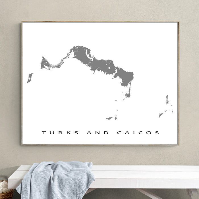Framed map of Turks and Caicos on a wall above a bench.