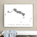 Framed map of Turks and Caicos on a wall above a bench.