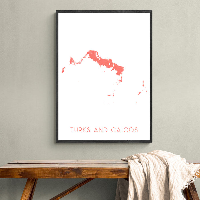 Framed map of Turks and Caicos on a wall above a wooden bench.