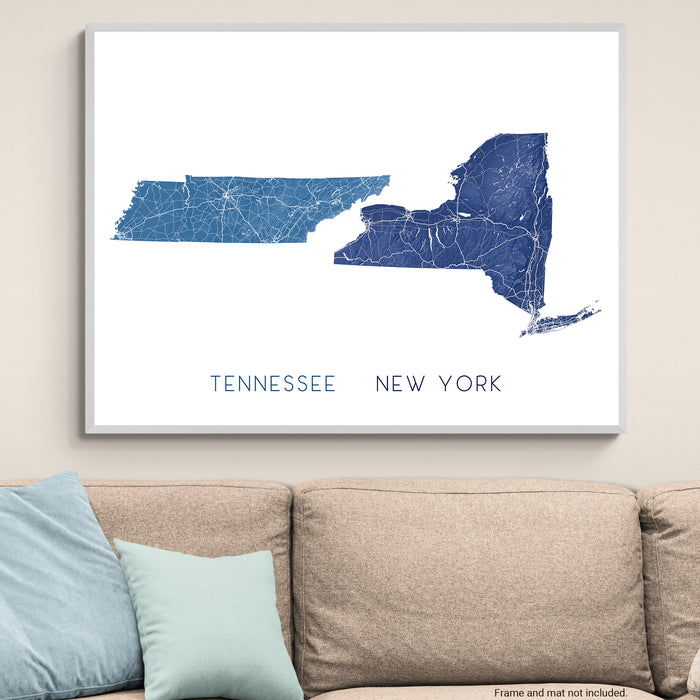 Map of Tennessee and New York on a wall above a beige sofa with light blue pillows.