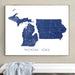 Framed map of Michigan and Iowa on a wall above a white bench.