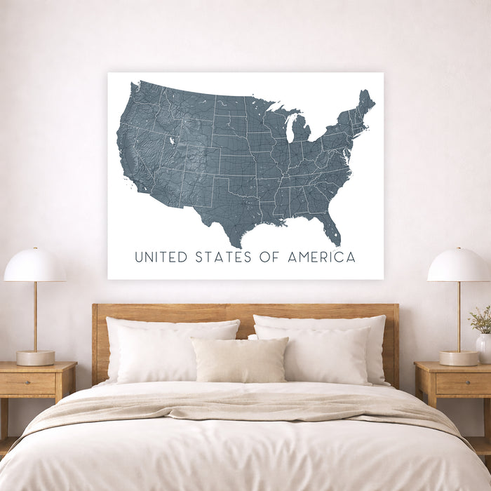Map of the United States on a wall above a bed in a bedroom setting