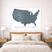 Map of the United States on a wall above a bed in a bedroom setting