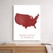 Map of the United States in red on a white background, displayed on a wall above a wooden surface.