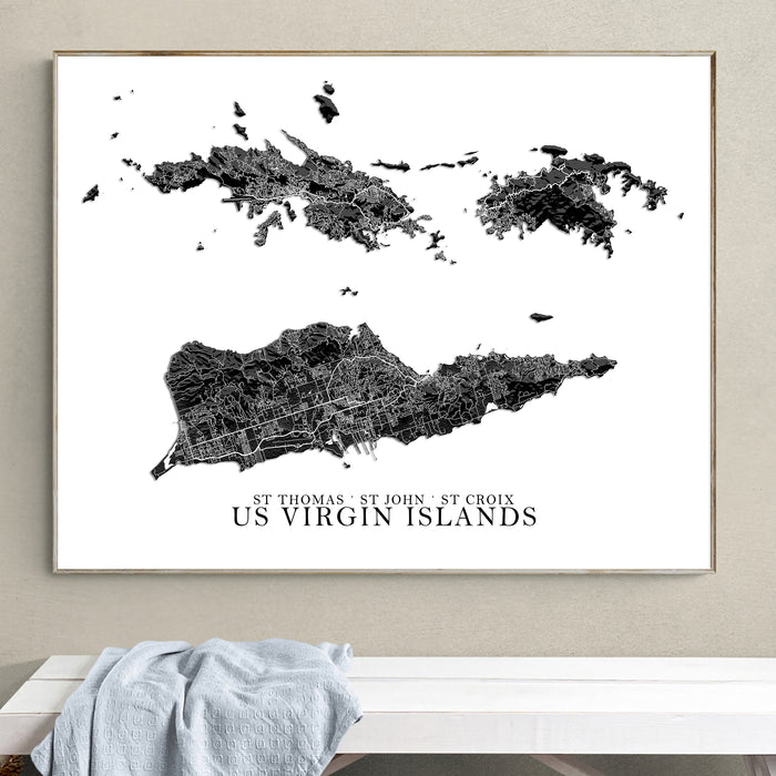Framed map of US Virgin Islands on a wall above a white surface.