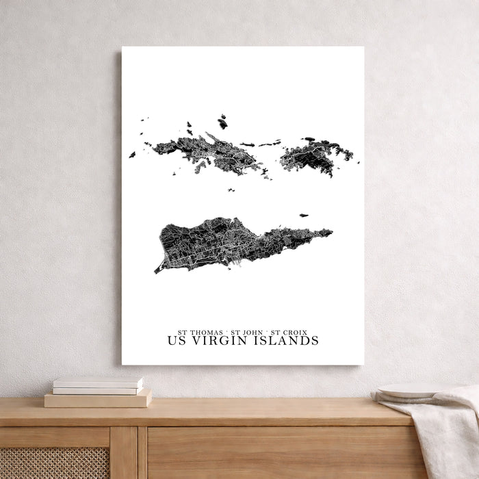 Map of US Virgin Islands on a white wall above a wooden shelf.