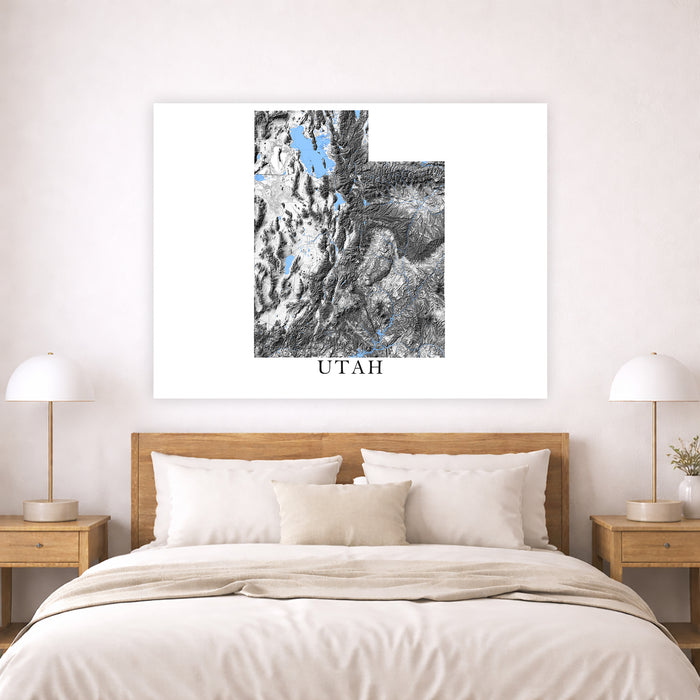 Framed artwork of Utah on a wall above a bed in a bedroom.