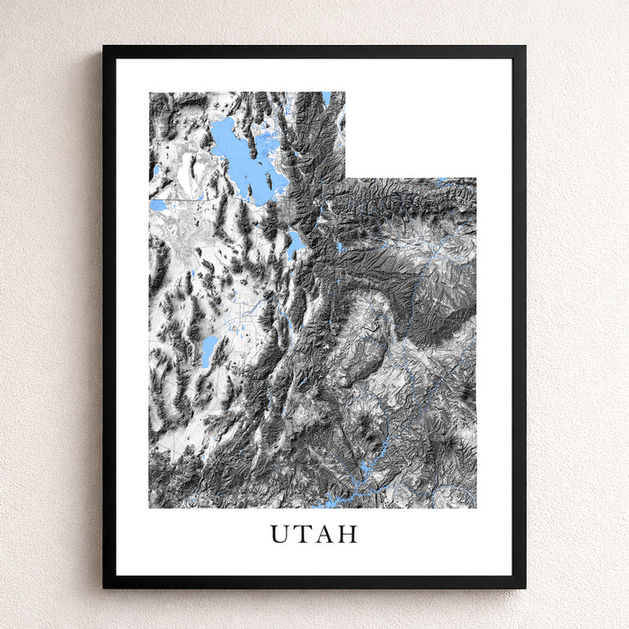 Framed map of Utah with topographic details on a white wall.