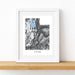 Framed map print of Utah on a wooden surface with a white background
