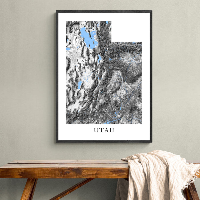 Framed map of Utah on a wall above a wooden bench.
