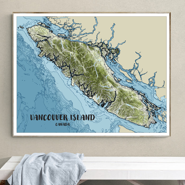 Framed map of Vancouver Island, Canada on a wall above a white surface.