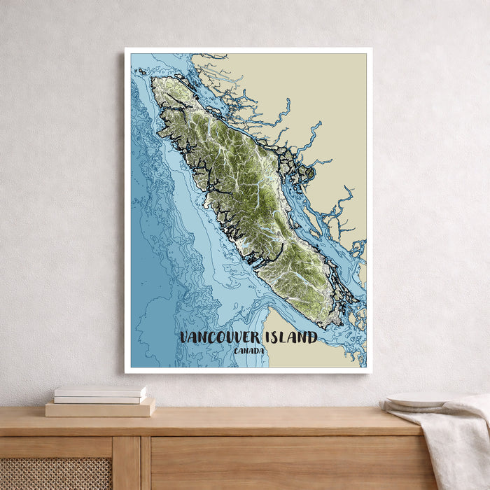 Framed map of Vancouver Island, Canada on a wall above a wooden surface.