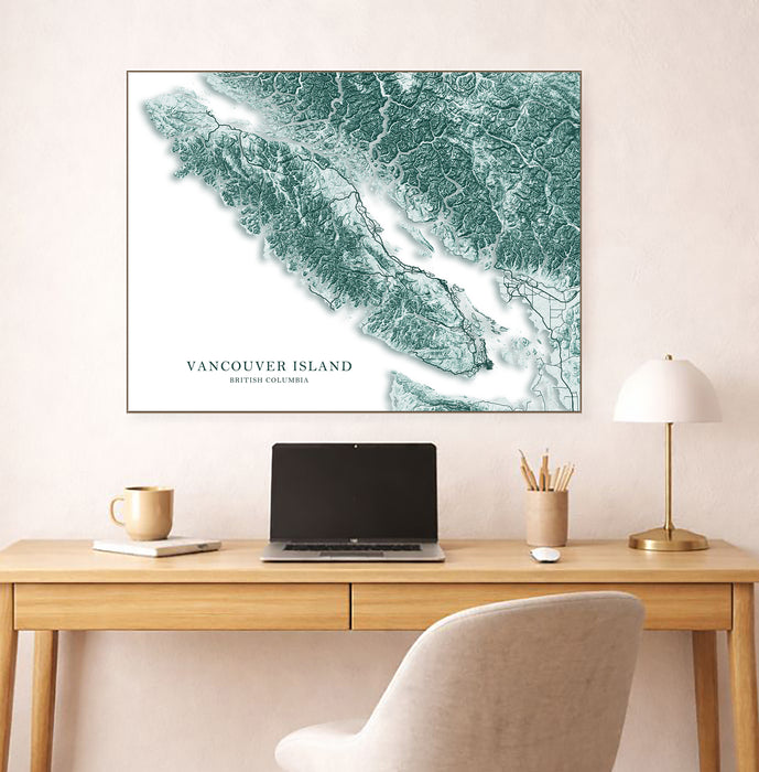Map of Vancouver Island on a wall above a desk with a laptop and lamp.