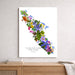 A vertical wall art print featuring a colorful floral map of Vancouver Island, Canada, styled on a light gray wall above a wooden console table with books and a throw blanket.