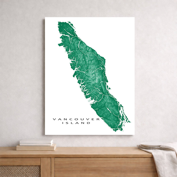 Map of Vancouver Island on a white background, displayed on a wall above a wooden surface.
