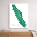 Map of Vancouver Island on a white background, displayed on a wall above a wooden surface.