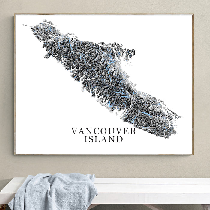 Framed map of Vancouver Island on a wall above a white bench.