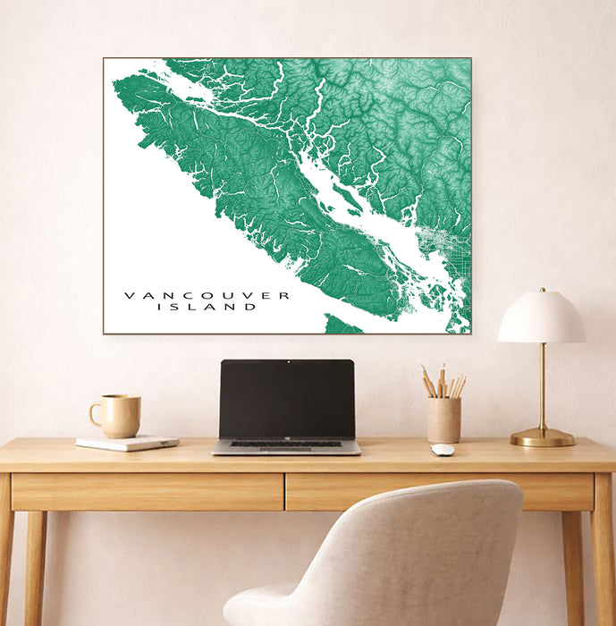 Map of Vancouver Island on a wall above a desk with a laptop and office items.