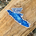 Sticker of Vancouver Island, Canada on a wooden surface