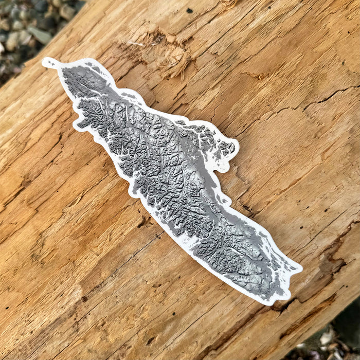 Map-shaped sticker on a wooden surface