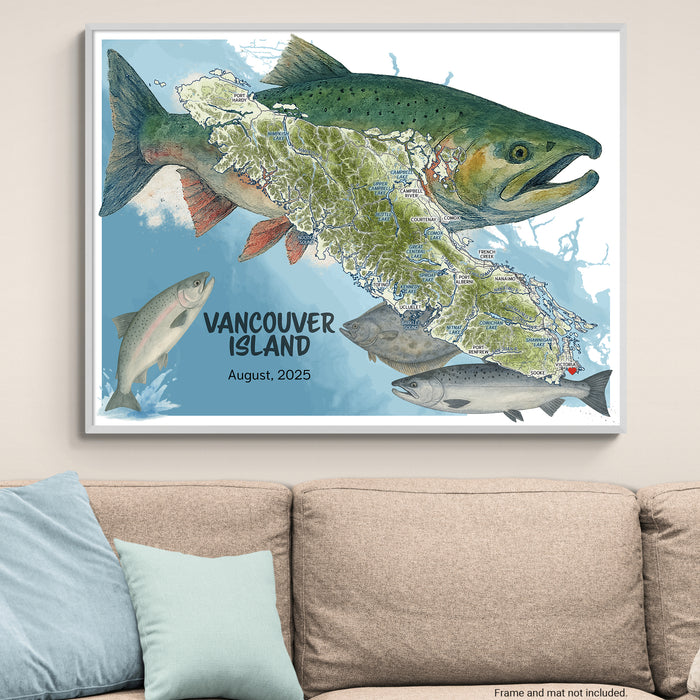 Framed map of Vancouver Island with salmon illustrations on a wall above a beige sofa.