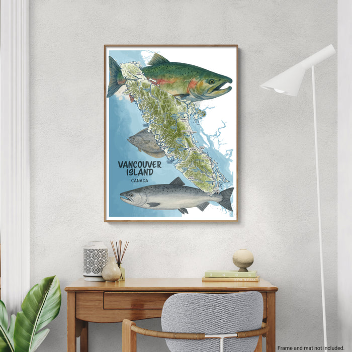Framed map of Vancouver Island with salmon illustrations on a wall above a desk.