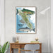 Framed map of Vancouver Island with salmon illustrations on a wall above a desk.