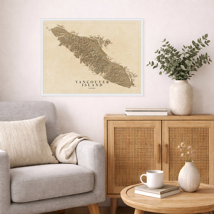 Living room with a map of Vancouver Island on the wall, a gray sofa, wooden cabinet, and small table with decor items.
