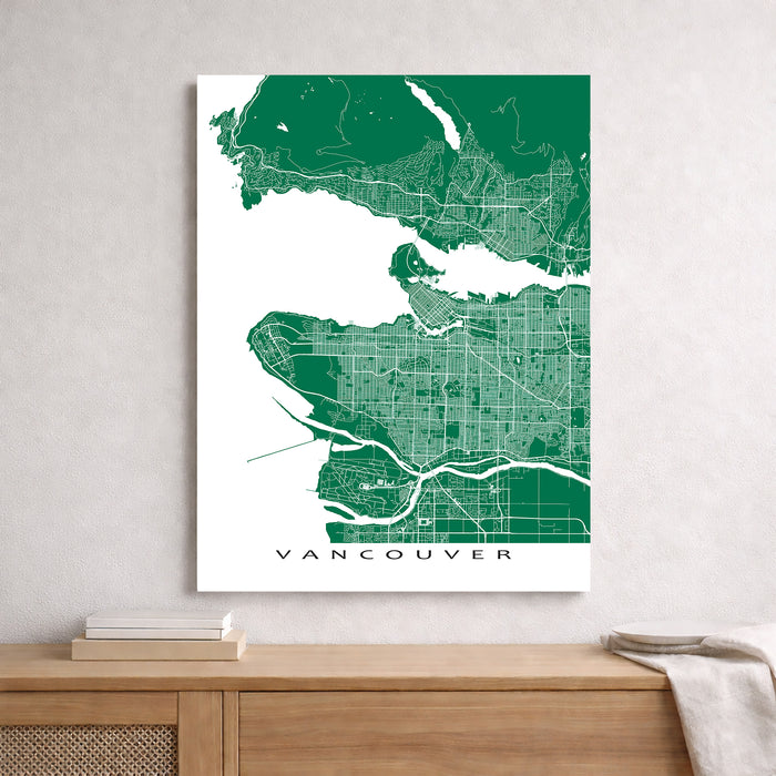 Map of Vancouver framed on a wall above a wooden surface