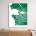 Map of Vancouver framed on a wall above a wooden surface