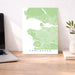 Map of Vancouver on a desk with a laptop and plant