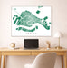 Framed map of Venice on a wall above a desk with a laptop and lamp.