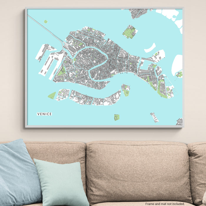 Framed map of Venice on a wall above a beige sofa with light blue cushions.