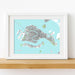 Framed map of Venice on a light blue background, displayed on a wooden surface.