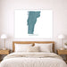 Map of Vermont on a wall above a bed in a bedroom setting