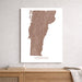 Map of Vermont on a white wall above a wooden shelf.