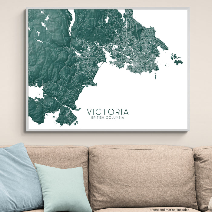 Map of Victoria, British Columbia on a wall above a beige sofa with light blue pillows.
