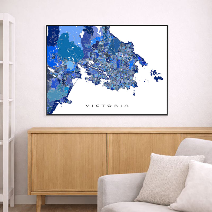 Framed map of Victoria on a wall above a wooden cabinet and sofa.