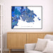 Framed map of Victoria on a wall above a wooden cabinet and sofa.
