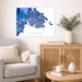 Living room with a map of Victoria on the wall, a couch, and a side table with a plant and books.