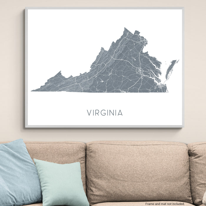Map of Virginia on a wall above a beige sofa with blue and light green pillows.