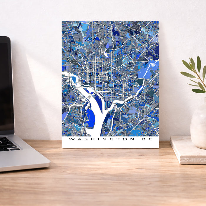 Washington DC map poster on a desk with a laptop and plant