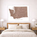 Map of Washington state on a wall above a bed in a bedroom.