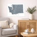 Living room with a gray sofa, wooden cabinet, and decorative items.