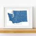 Framed map of Washington state on a white wall