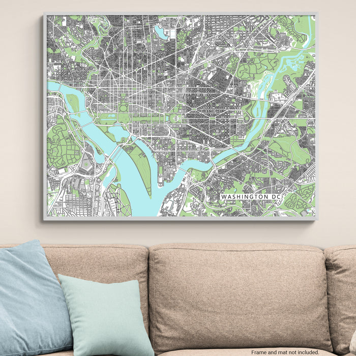 Framed map of Washington DC on a wall above a beige sofa with light blue pillows.